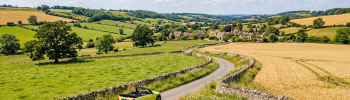 Convertible car hire driving through british countryside