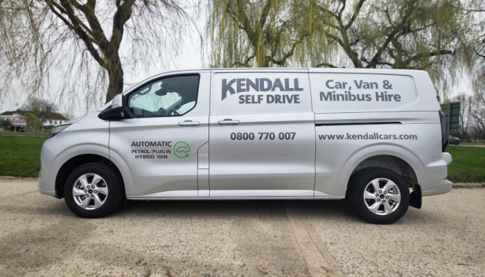 A gray SWB Transit Custom PHEV available for hire at Kendall Cars.